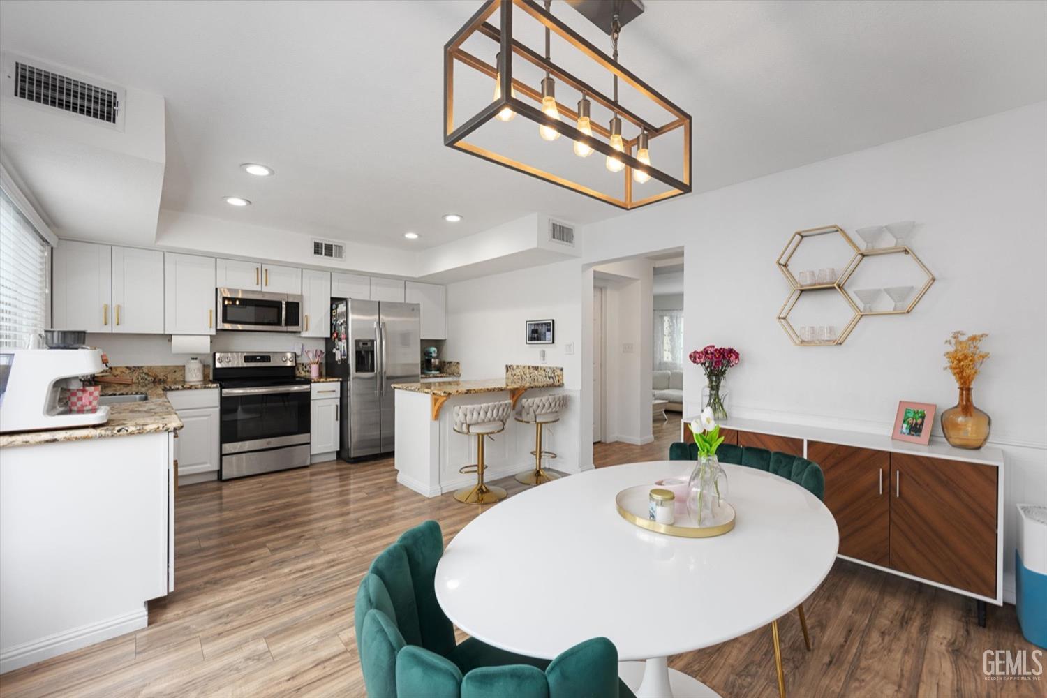 Undisclosed Address Bakersfield, CA 93308 - Photo 24 of 40 a large kitchen with a table and chairs