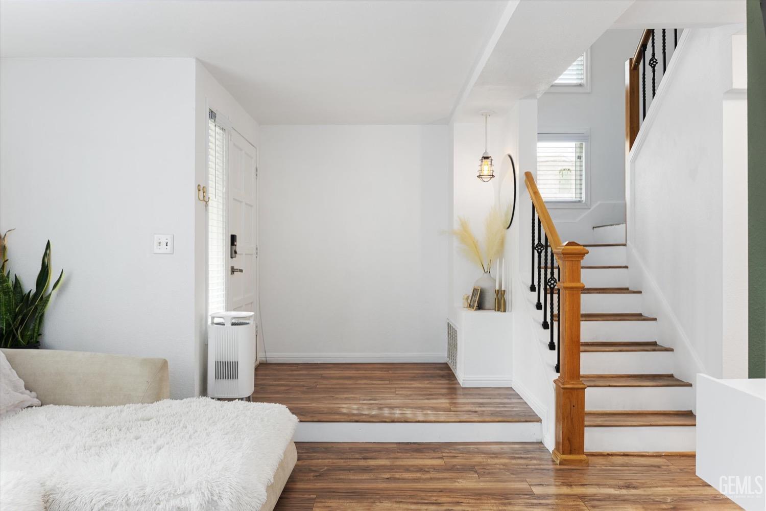 Undisclosed Address Bakersfield, CA 93308 - Photo 26 of 40 a view of a bedroom with wooden floor and stairs