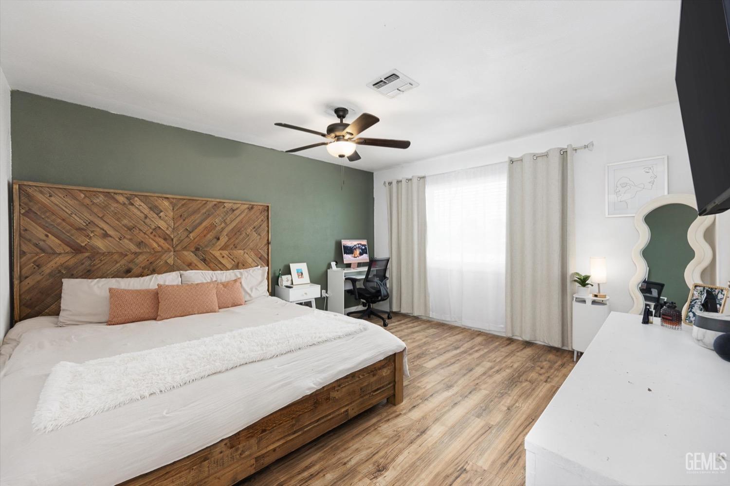 Undisclosed Address Bakersfield, CA 93308 - Photo 29 of 40 a bedroom with a bed and a chandelier