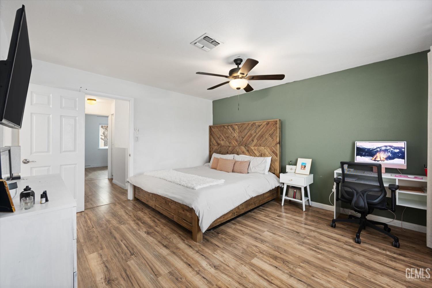 Undisclosed Address Bakersfield, CA 93308 - Photo 31 of 40 a bedroom with a bed and a chandelier