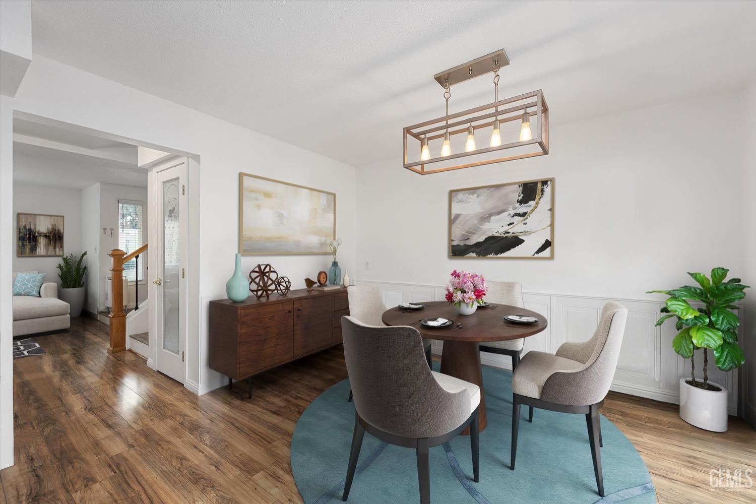 Undisclosed Address Bakersfield, CA 93308 - Photo 4 of 40 a view of a dining room with furniture and wooden floor
