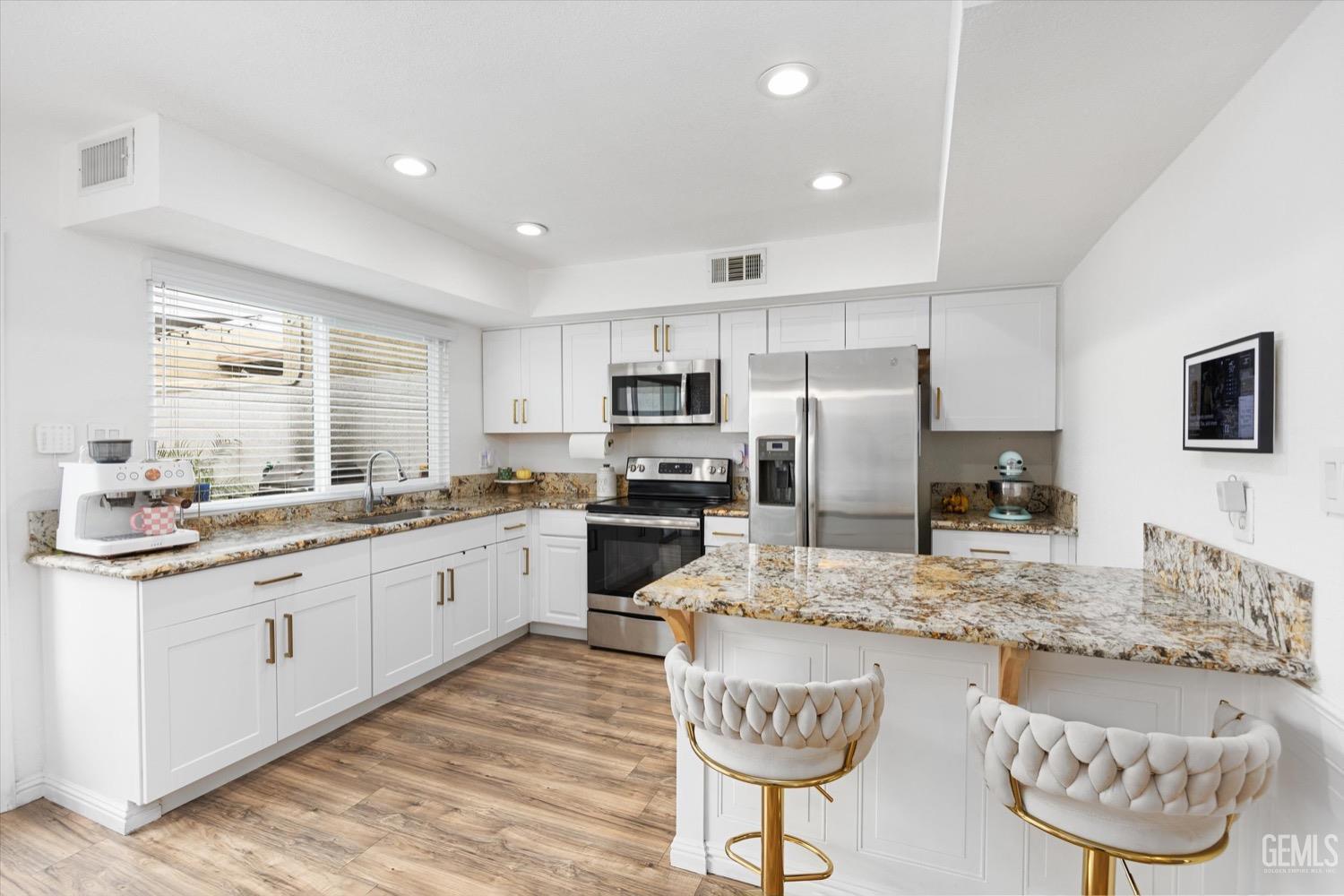 Undisclosed Address Bakersfield, CA 93308 - Photo 6 of 40 a kitchen with stainless steel appliances granite countertop a sink refrigerator and cabinets