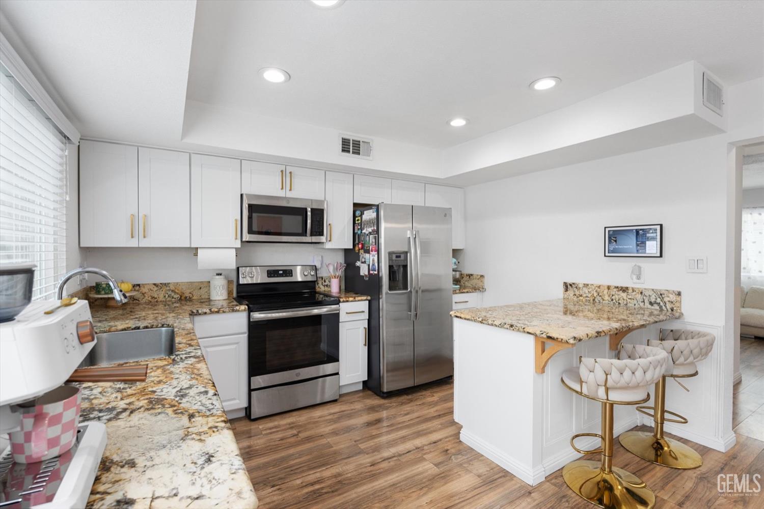 Undisclosed Address Bakersfield, CA 93308 - Photo 8 of 40 a kitchen with granite countertop appliances a sink and a counter top space