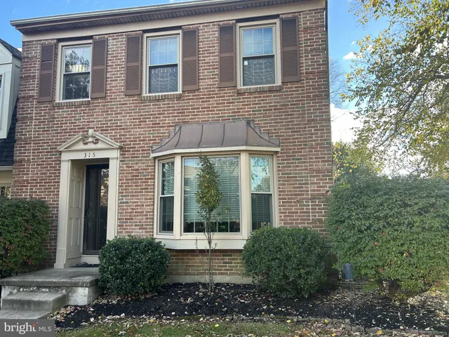 a brick house with a large windows