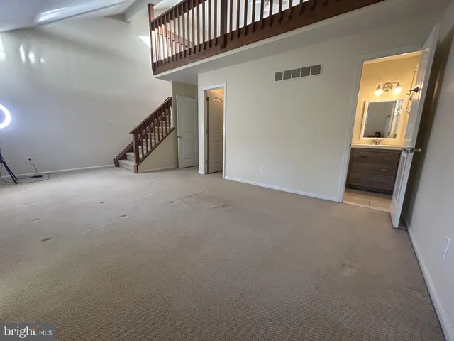 a view of an empty room with stairs