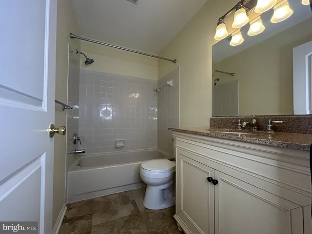 a bathroom with a toilet and a mirror