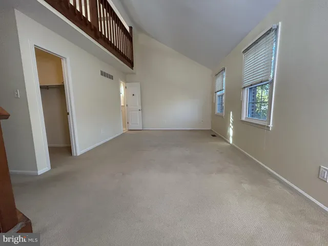 a view of an empty room with windows