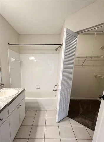 a bathroom with a sink a toilet a mirror and shower