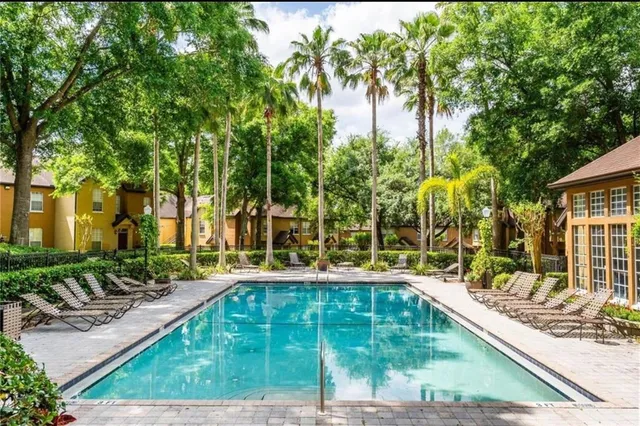 a swimming pool view with a garden