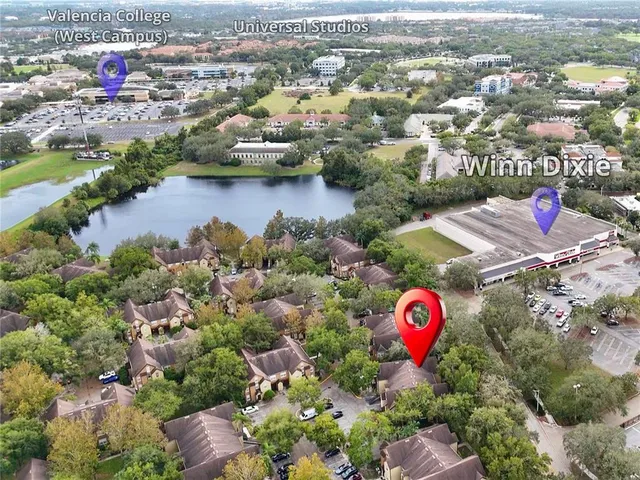 an aerial view of a houses with swimming pool