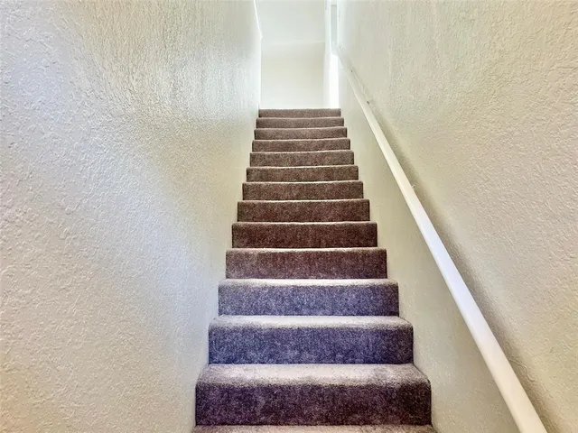 a view of staircase with white walls