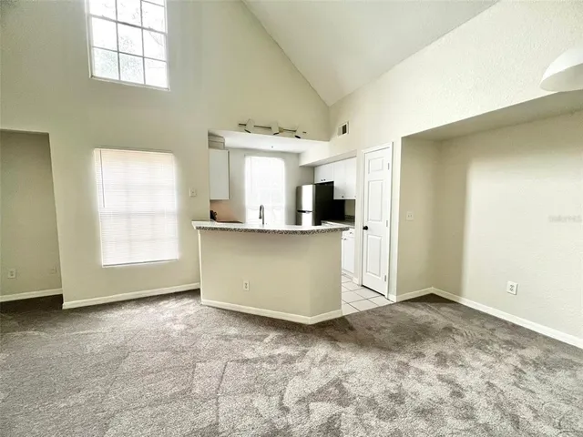 a view of a kitchen with wooden floor and electronic appliances