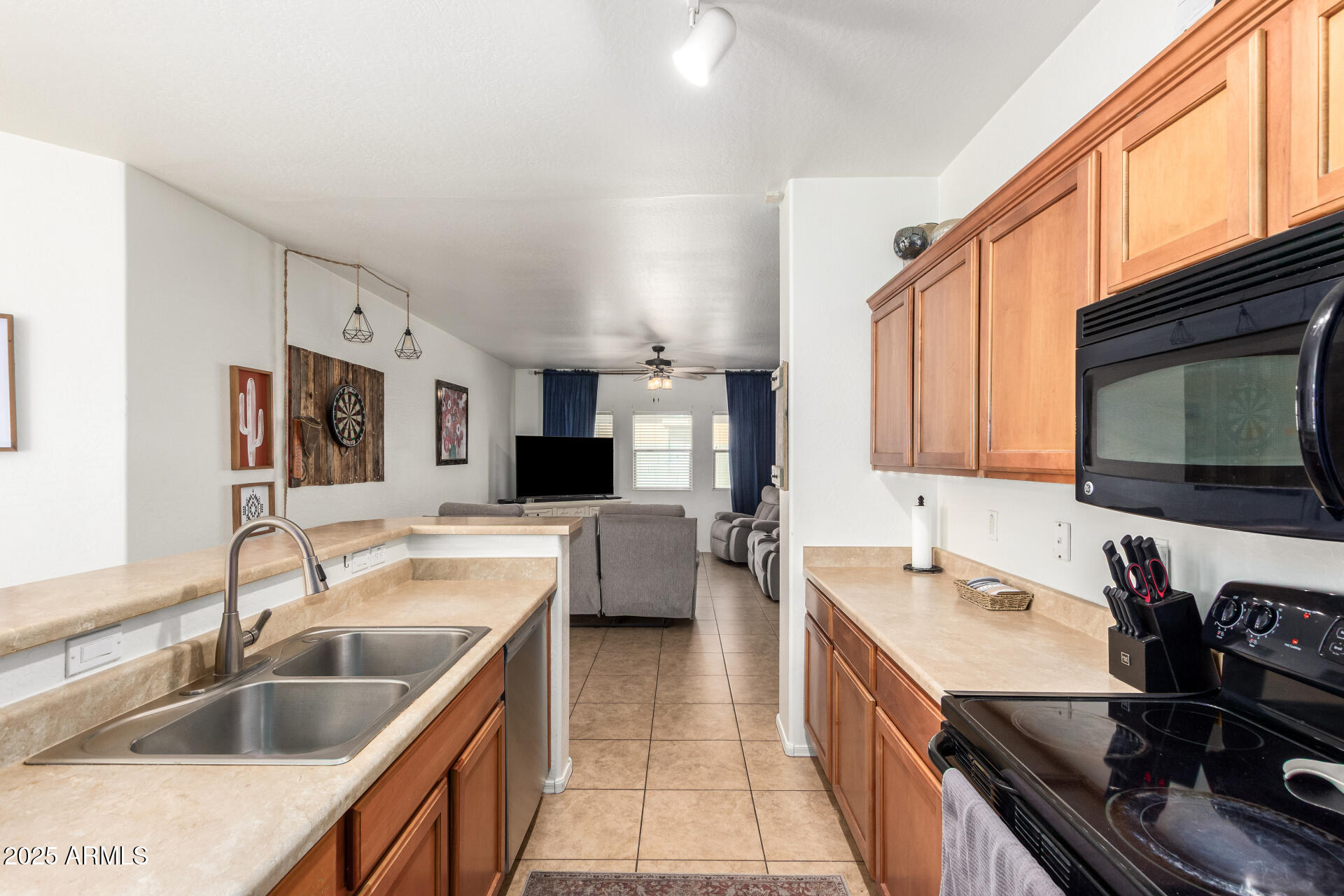 16947 West Cocopah Street Goodyear, AZ 85338 - Photo 14 of 22 a kitchen with a sink stove top oven and microwave