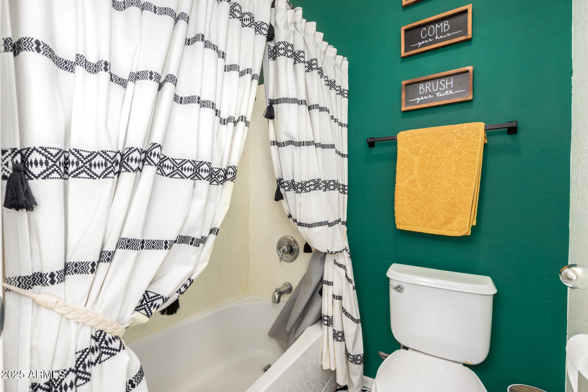 16947 West Cocopah Street Goodyear, AZ 85338 - Photo 19 of 22 a bathroom with a toilet and a shower curtain