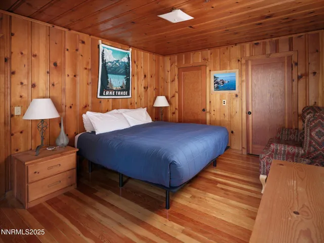 a bedroom with furniture and a air conditioner vent