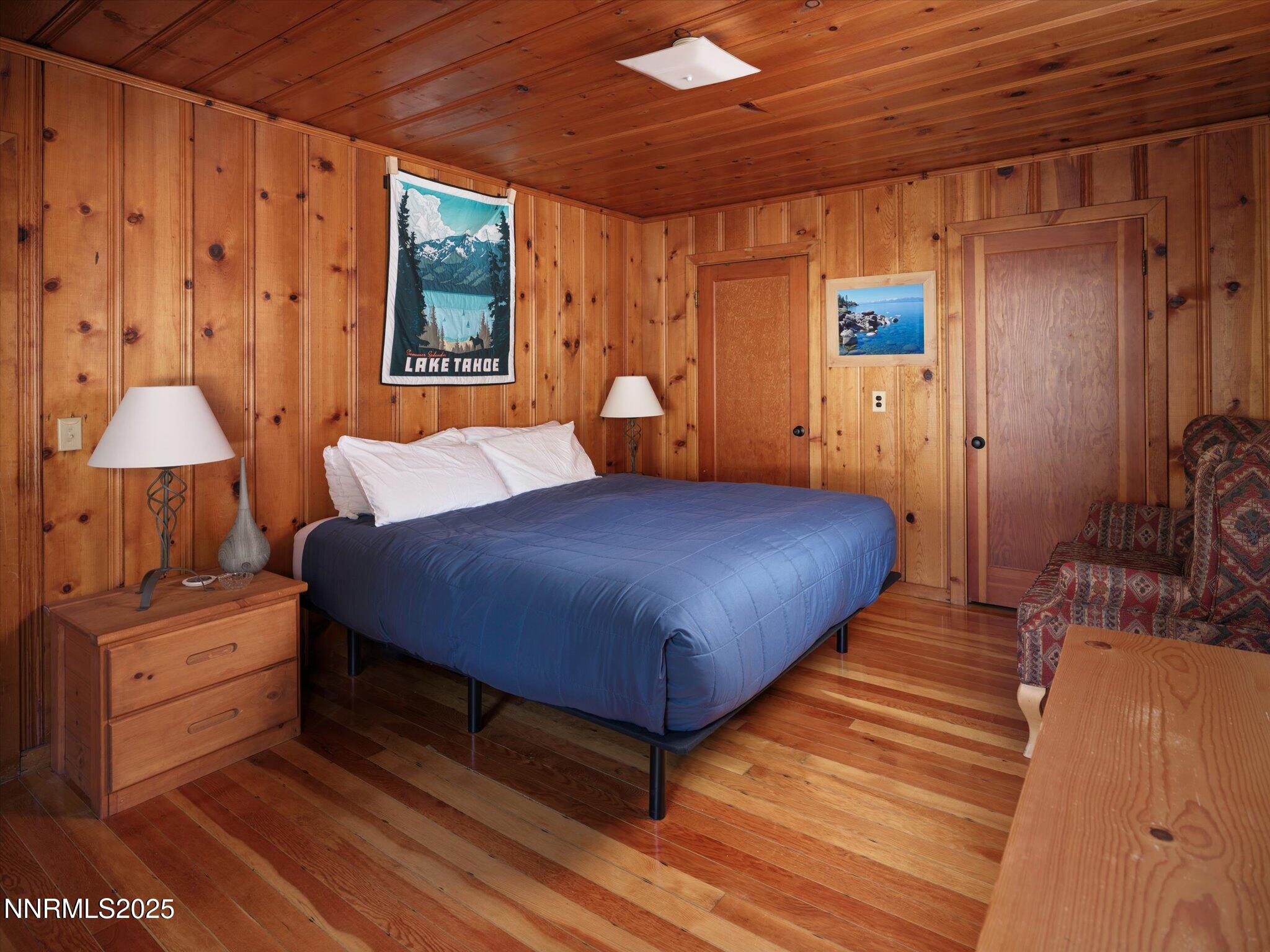 644 Job Lane Zephyr Cove, NV 89448 - Photo 11 of 26 a bedroom with a bed closet and a large window