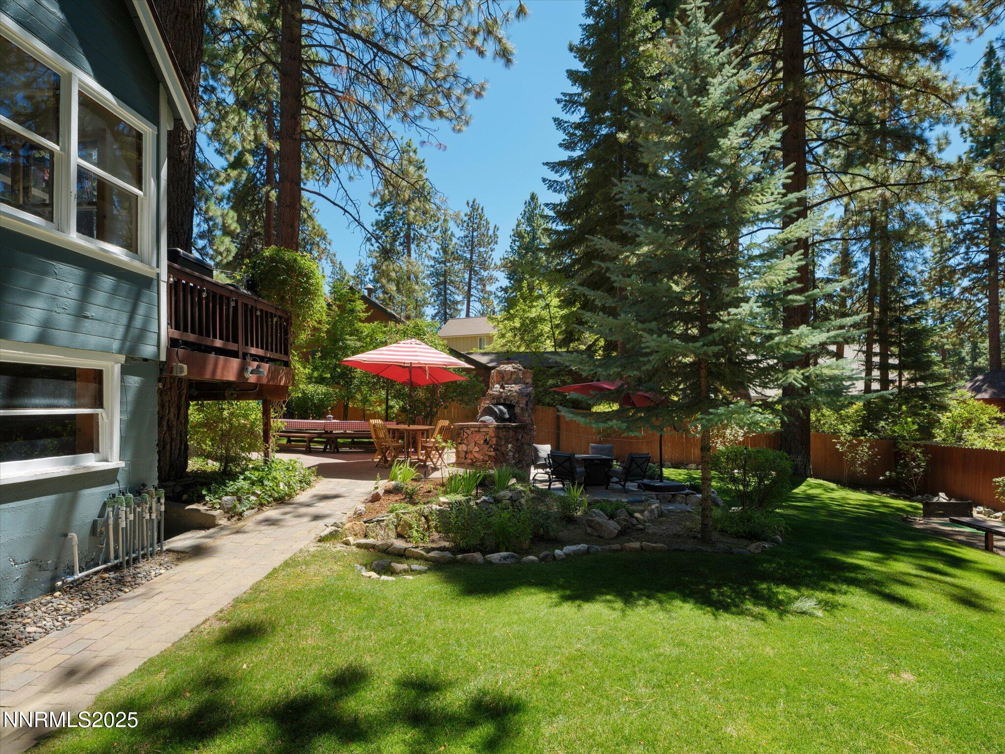 644 Job Lane Zephyr Cove, NV 89448 - Photo 18 of 26 a view of a patio with table and chairs under an umbrella