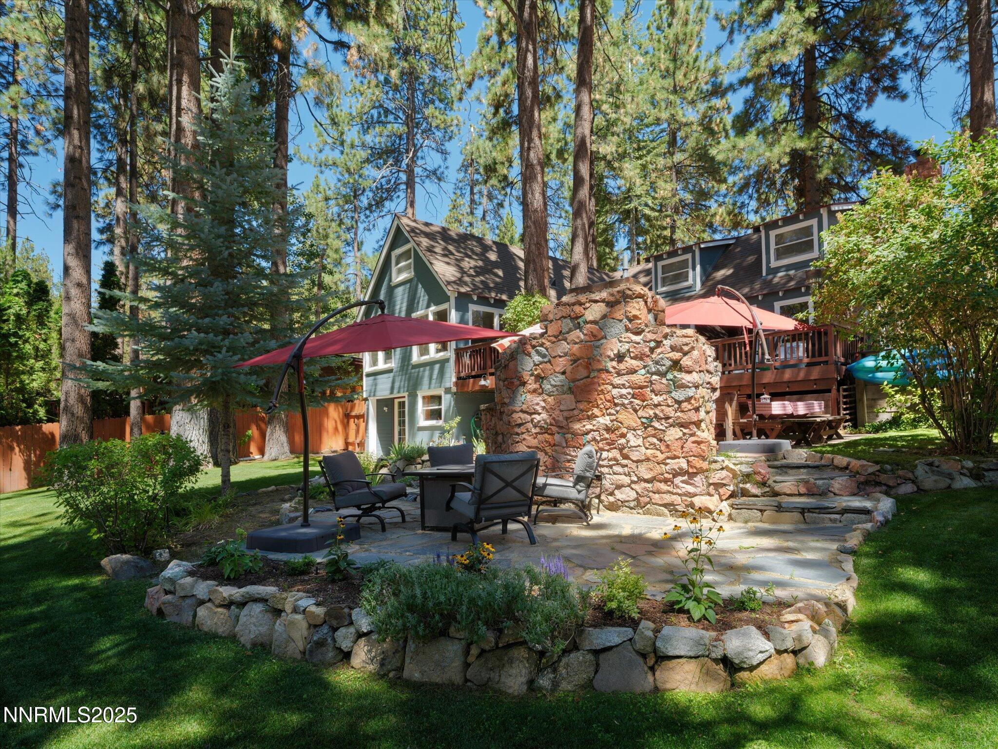 644 Job Lane Zephyr Cove, NV 89448 - Photo 19 of 26 a backyard of a house with table and chairs