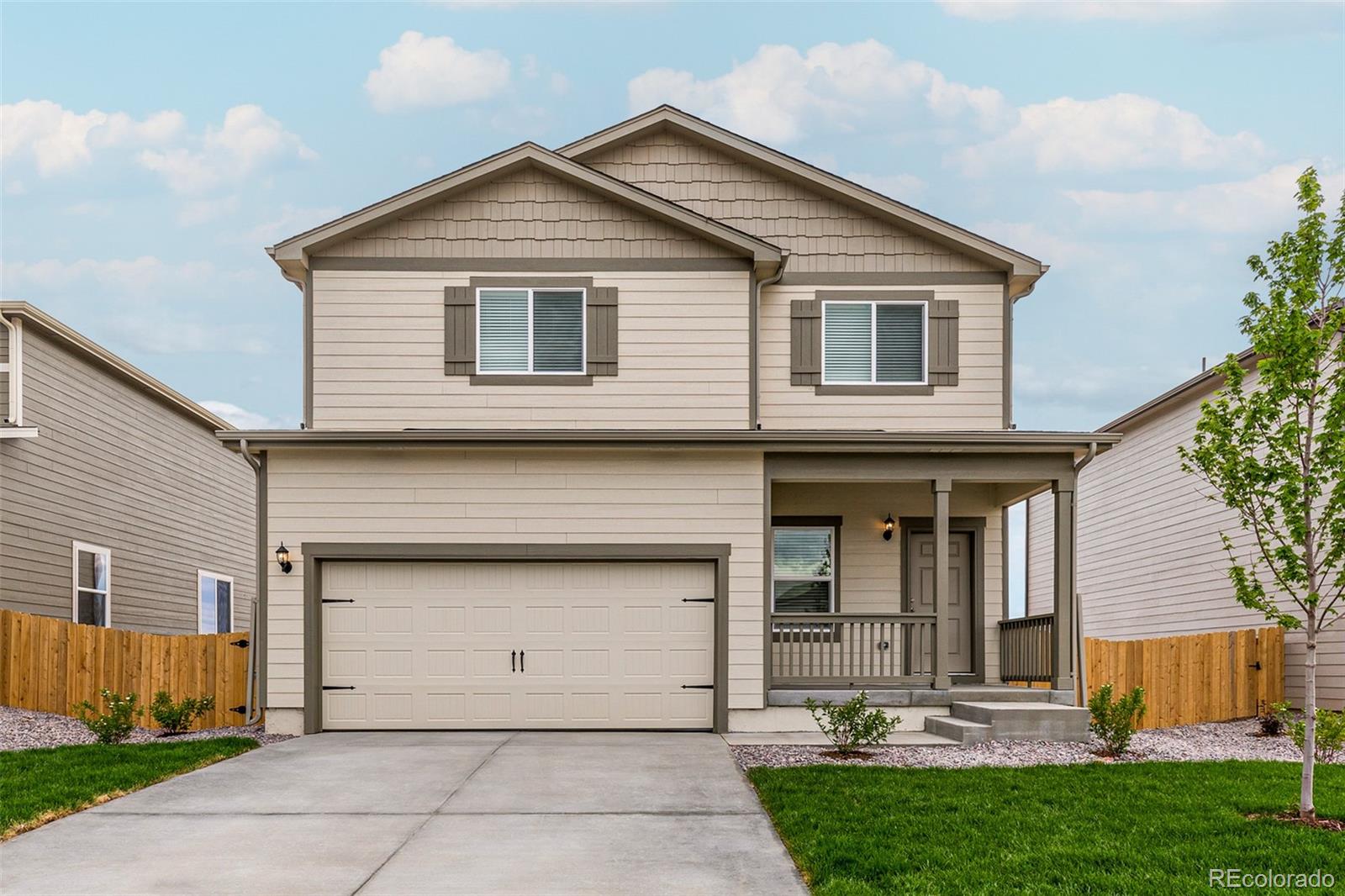 7003 Fall River Drive Frederick, CO 80530 - Photo 1 of 14 a front view of a house with garage