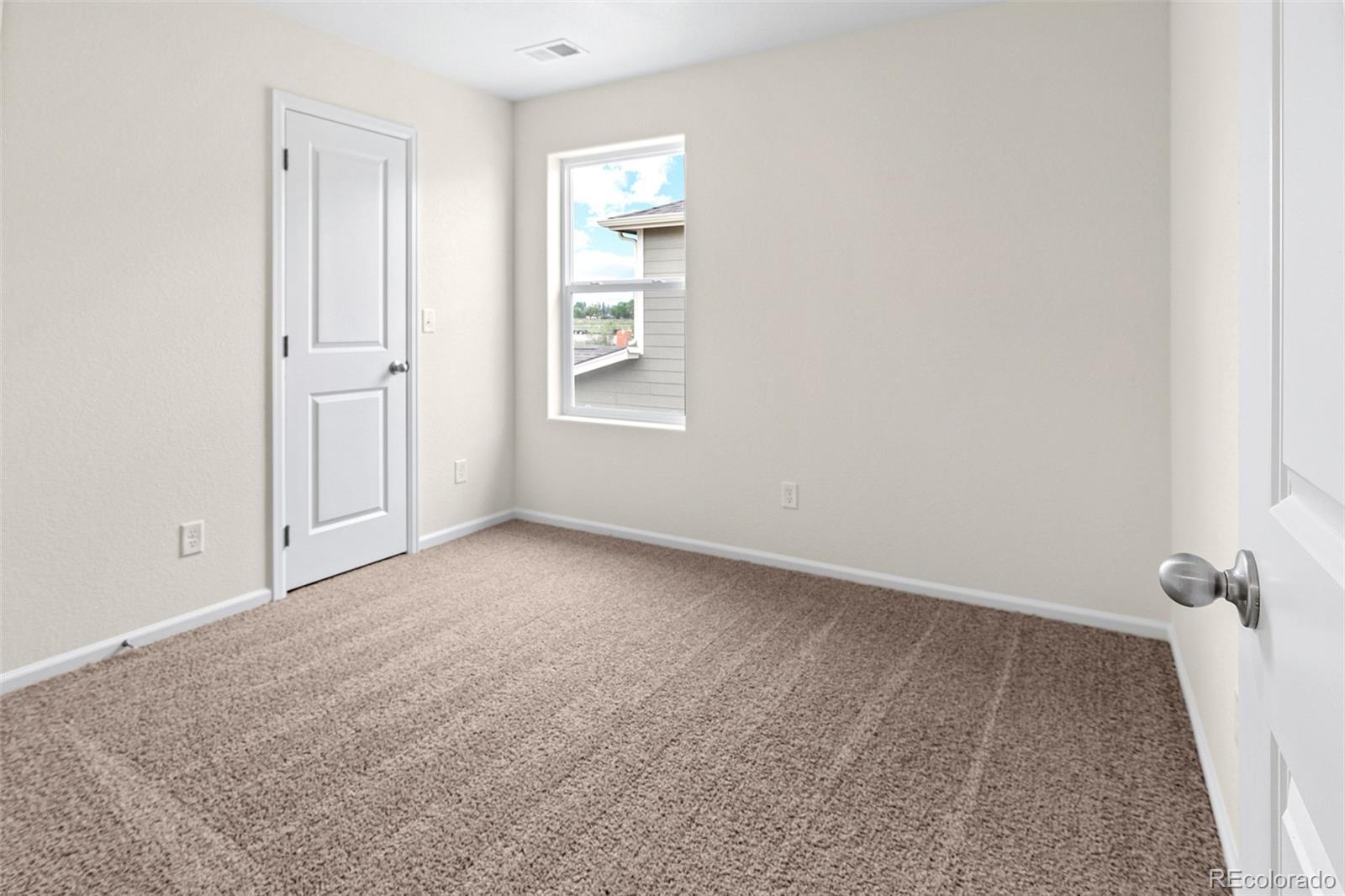 7003 Fall River Drive Frederick, CO 80530 - Photo 11 of 14 an empty room with windows