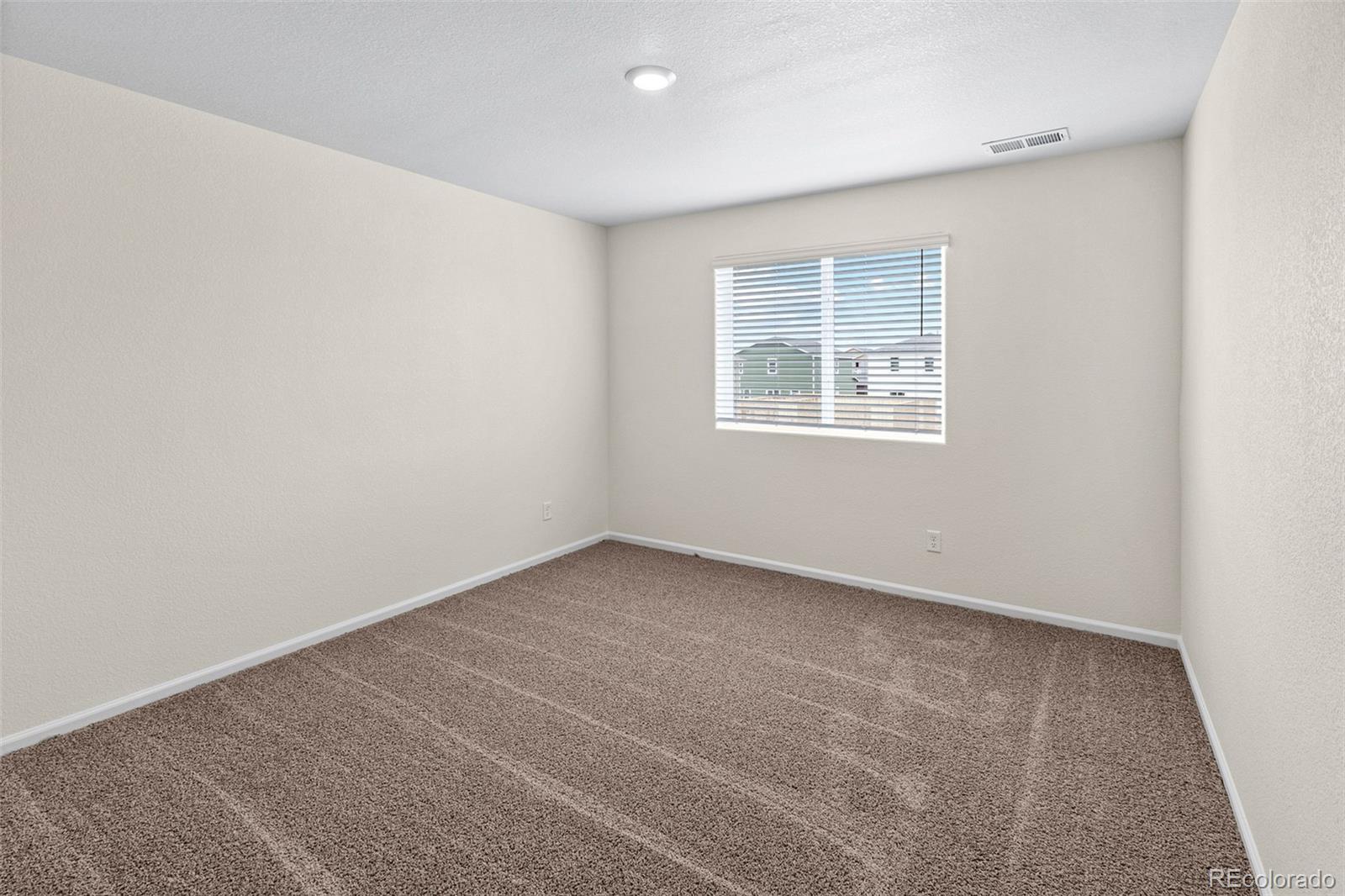 7003 Fall River Drive Frederick, CO 80530 - Photo 12 of 14 an empty room with a window