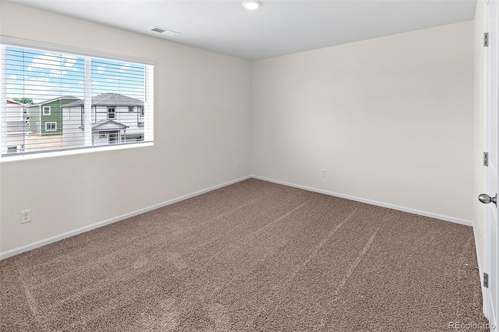 7003 Fall River Drive Frederick, CO 80530 - Photo 13 of 14 an empty room with a window