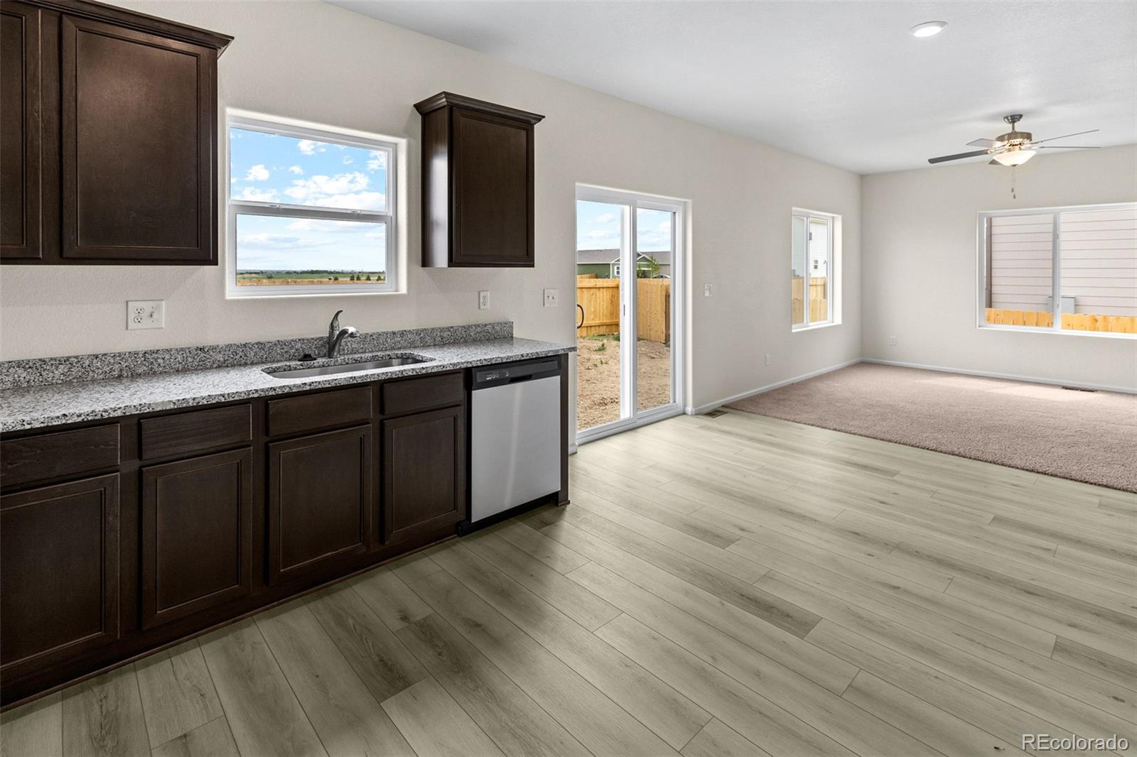 7003 Fall River Drive Frederick, CO 80530 - Photo 4 of 14 a spacious bathroom with a granite countertop sink toilet a mirror and window