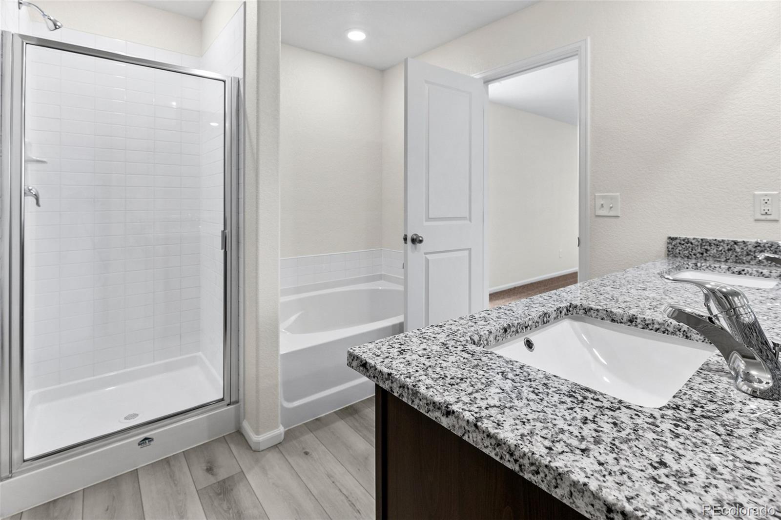 7003 Fall River Drive Frederick, CO 80530 - Photo 9 of 14 a bathroom with a granite countertop sink a mirror and shower