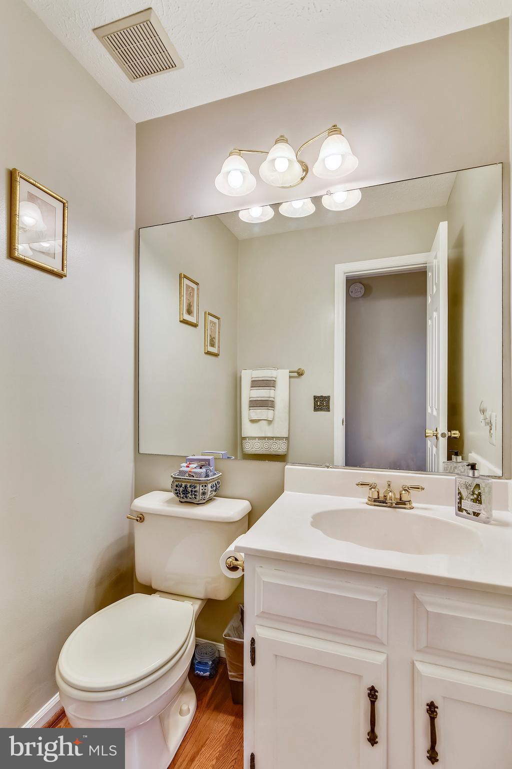 103 Rector Street Sterling, VA 20164 - Photo 11 of 25 Powder room with hardwood floors