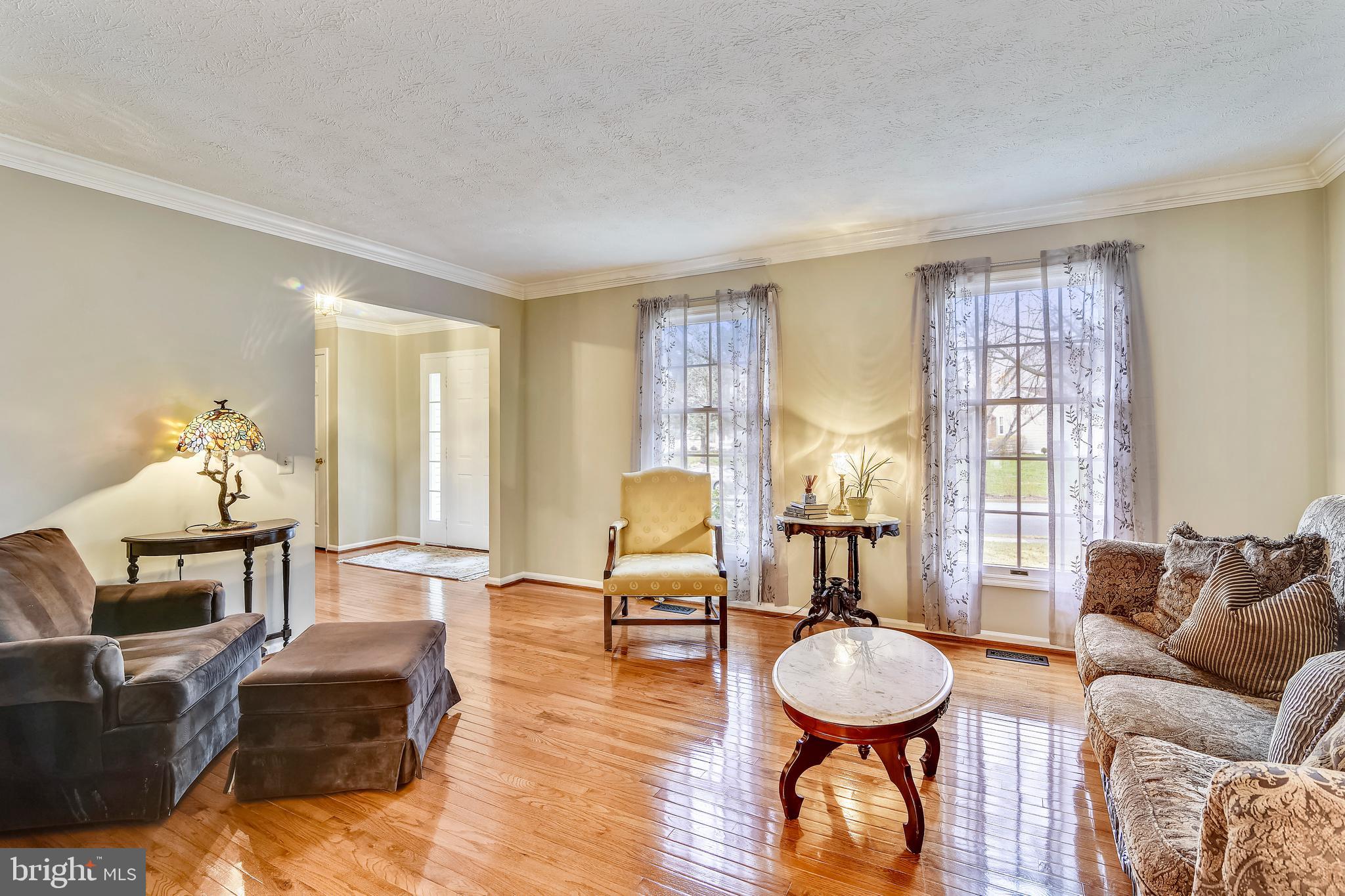 103 Rector Street Sterling, VA 20164 - Photo 3 of 25 Living room has hardwood floors & crown molding