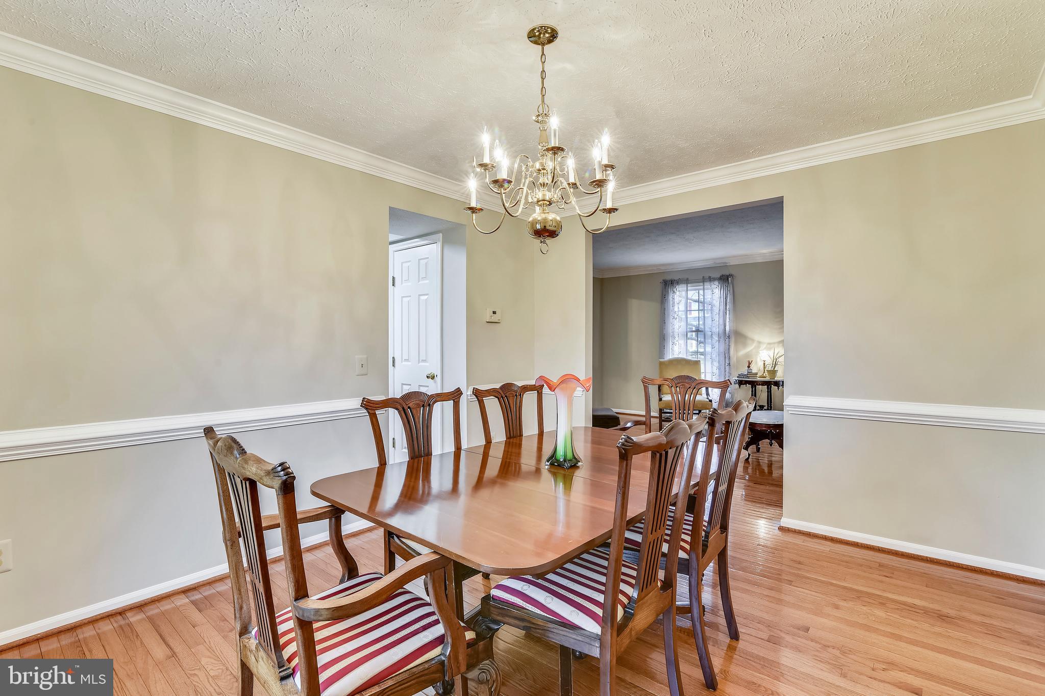 103 Rector Street Sterling, VA 20164 - Photo 4 of 25 Dining room with chair rail and crown molding