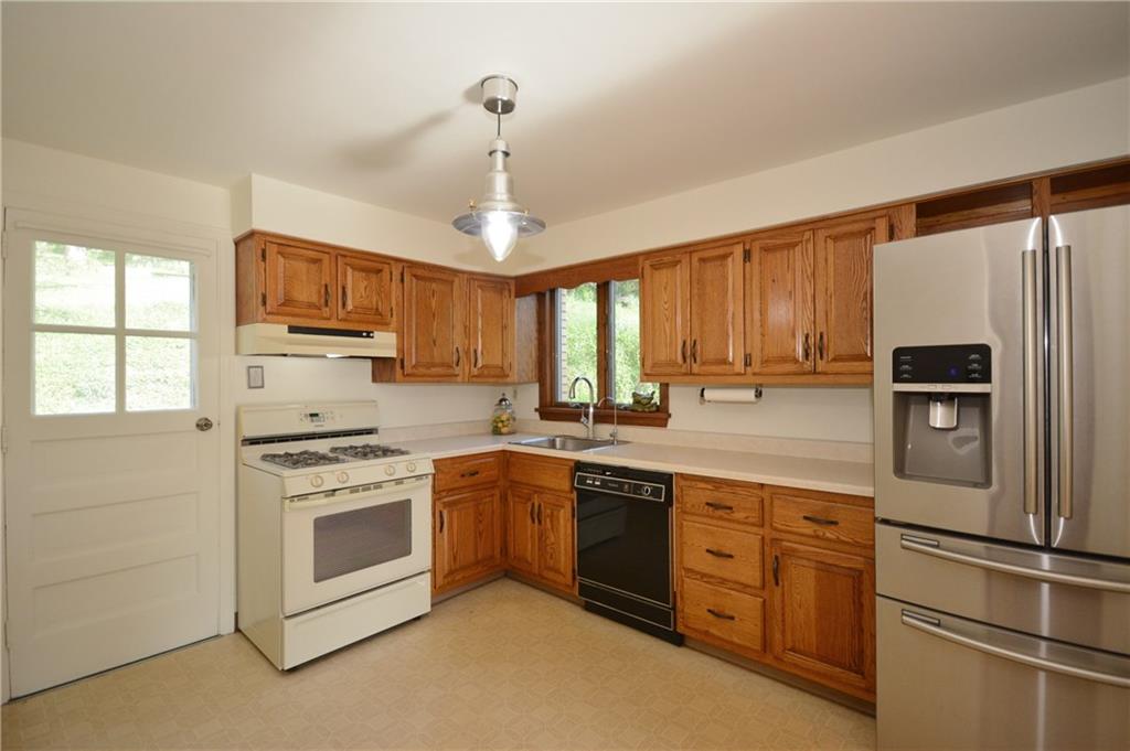 3201 Provost Road Pittsburgh, PA 15227 - Photo 7 of 25 The kitchen is a good size and could accomodate a small table, or better yet, a rolling cart to use as an island. The oak cabinets have updated bronze pulls. All appliances are included. This door leads you out to the backyard.
