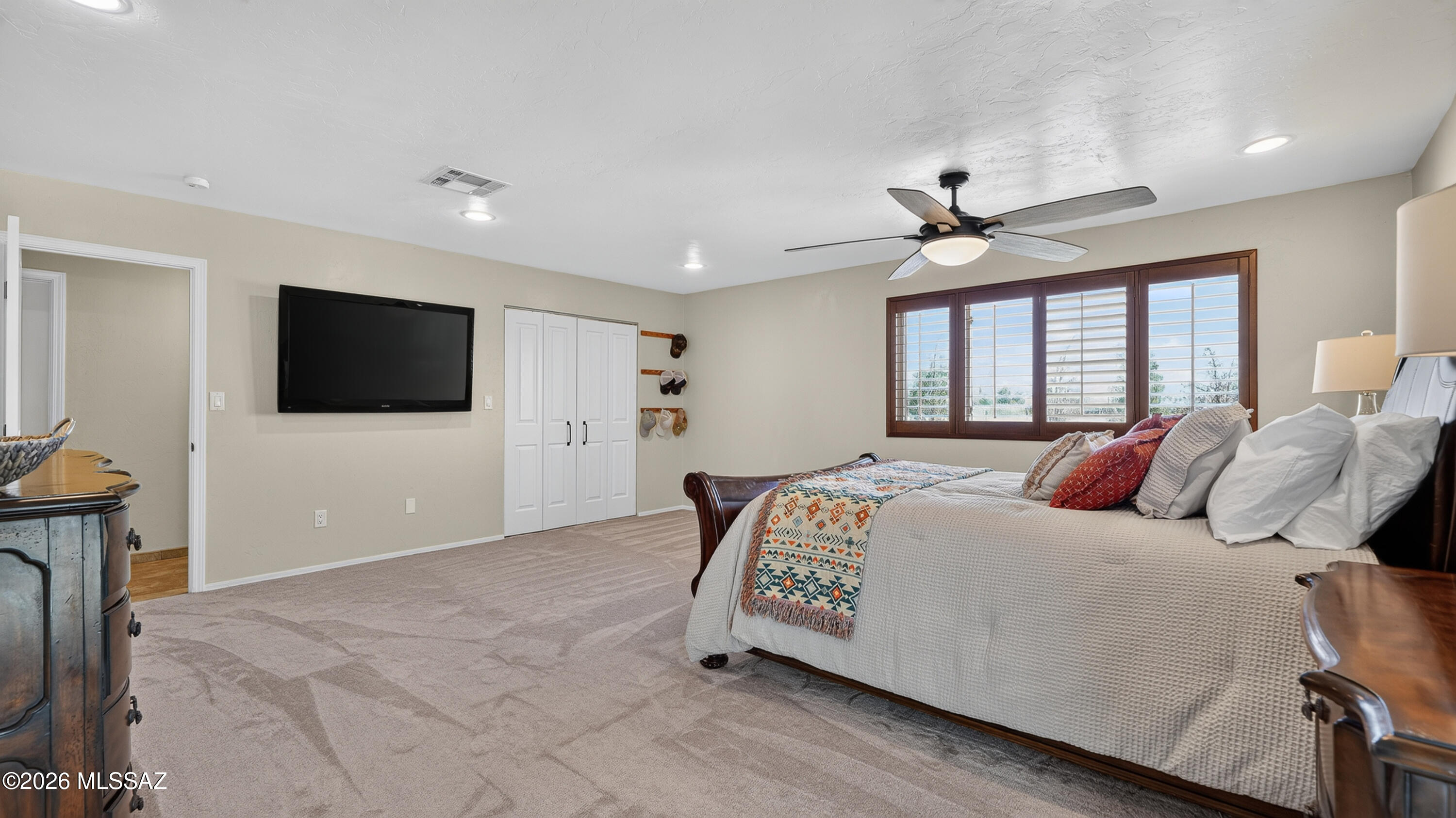 194 Taylor Road Willcox, AZ 85643 - Photo 23 of 54 Primary Bedroom with New Carpet (6.26), Custom Wooden Window Shutters and 2 large Closets, 72" Ceiling Fan and Dimmable Can lighting