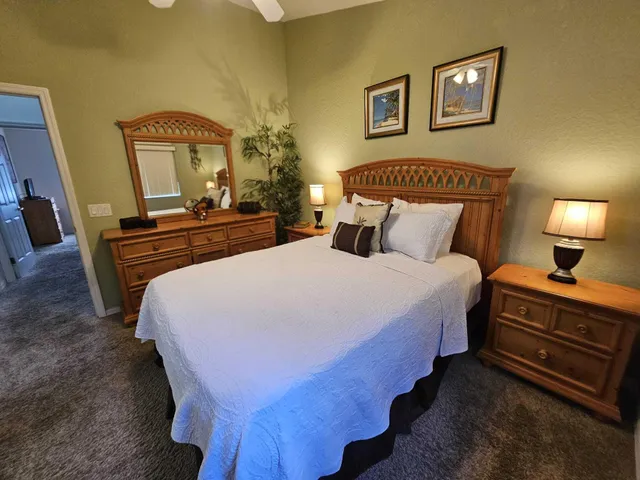 a bedroom with bed and wooden floor