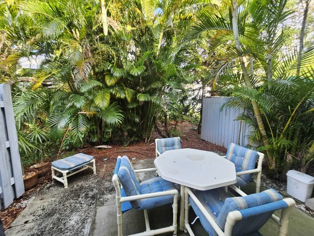 a backyard of a house with table and chairs