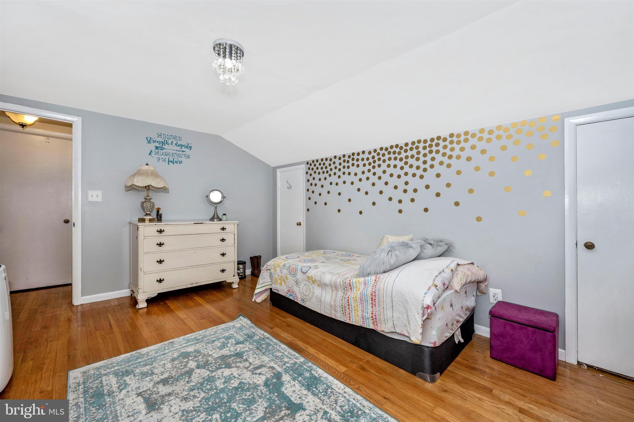 4304 Ridge Avenue Baltimore, MD 21227 - Photo 24 of 50 a bedroom with a bed and wooden floor