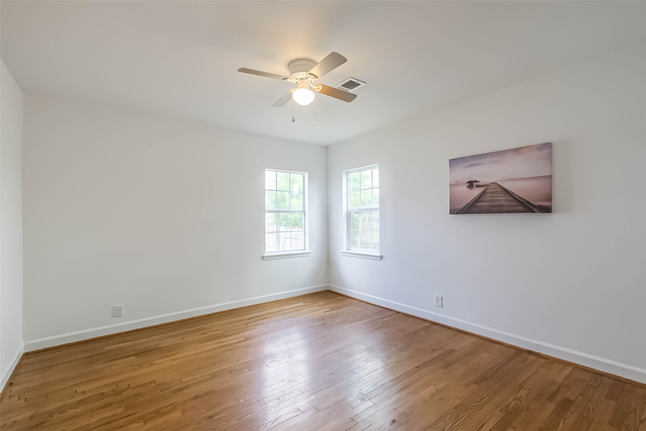 7543 Greenstone Street Houston, TX 77087 - Photo 10 of 24 wooden floor in an empty room with a window