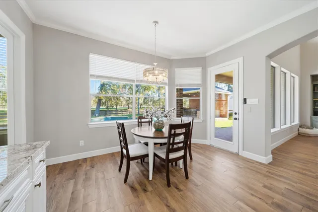 a kitchen with cabinets and wooden floor
