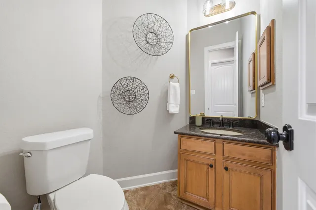 a large white kitchen with a sink and dishwasher a stove with wooden floor