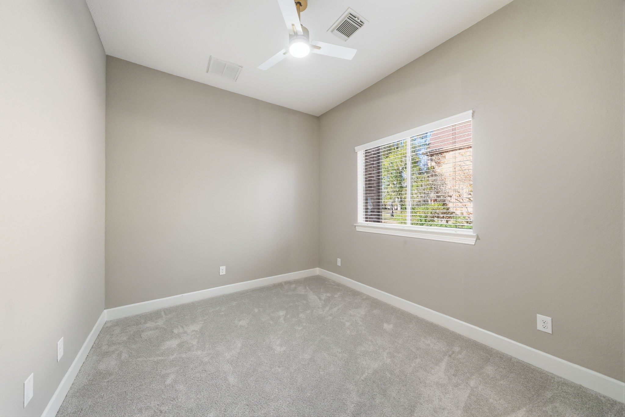 32807 Whitburn Trail Fulshear, TX 77441 - Photo 22 of 39 an empty room with windows and chandelier fan