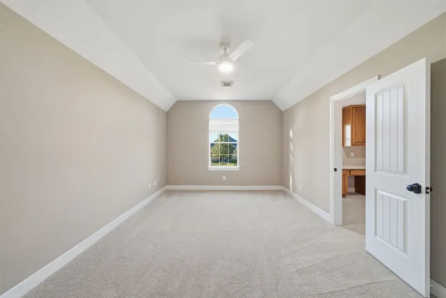 a view of a livingroom with furniture workspace window and wooden floor