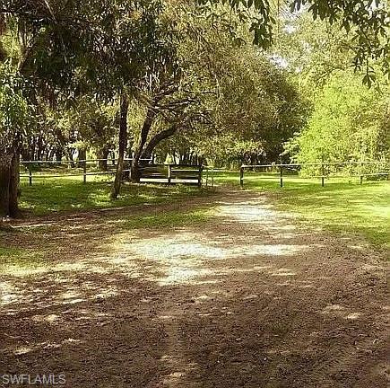 23261 Tuckahoe Road Alva, FL 33920 - Photo 14 of 39 a swimming pool with outdoor seating and yard