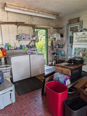 a room with stainless steel appliances kitchen island a table and chairs in it