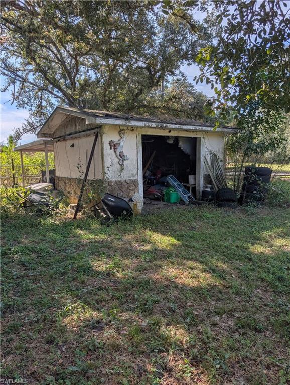 23261 Tuckahoe Road Alva, FL 33920 - Photo 31 of 39 a view of a house with yard and a tree