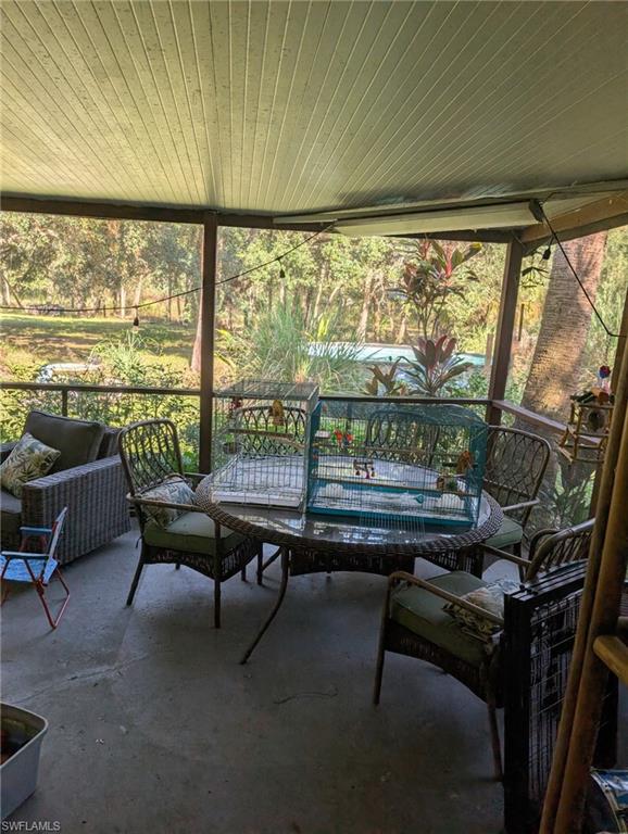 23261 Tuckahoe Road Alva, FL 33920 - Photo 38 of 39 a living room with furniture and a large window