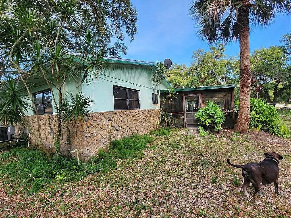 23261 Tuckahoe Road Alva, FL 33920 - Photo 4 of 39 a front view of a house with garden