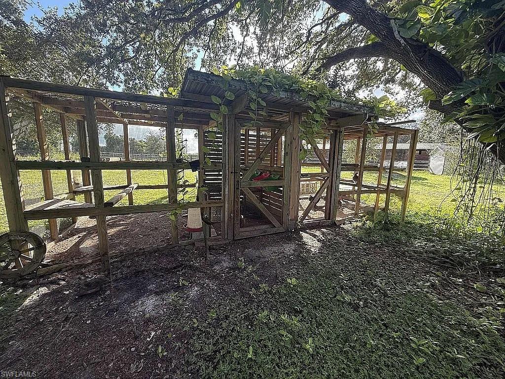 23261 Tuckahoe Road Alva, FL 33920 - Photo 9 of 39 a view of a yard with plants and large tree