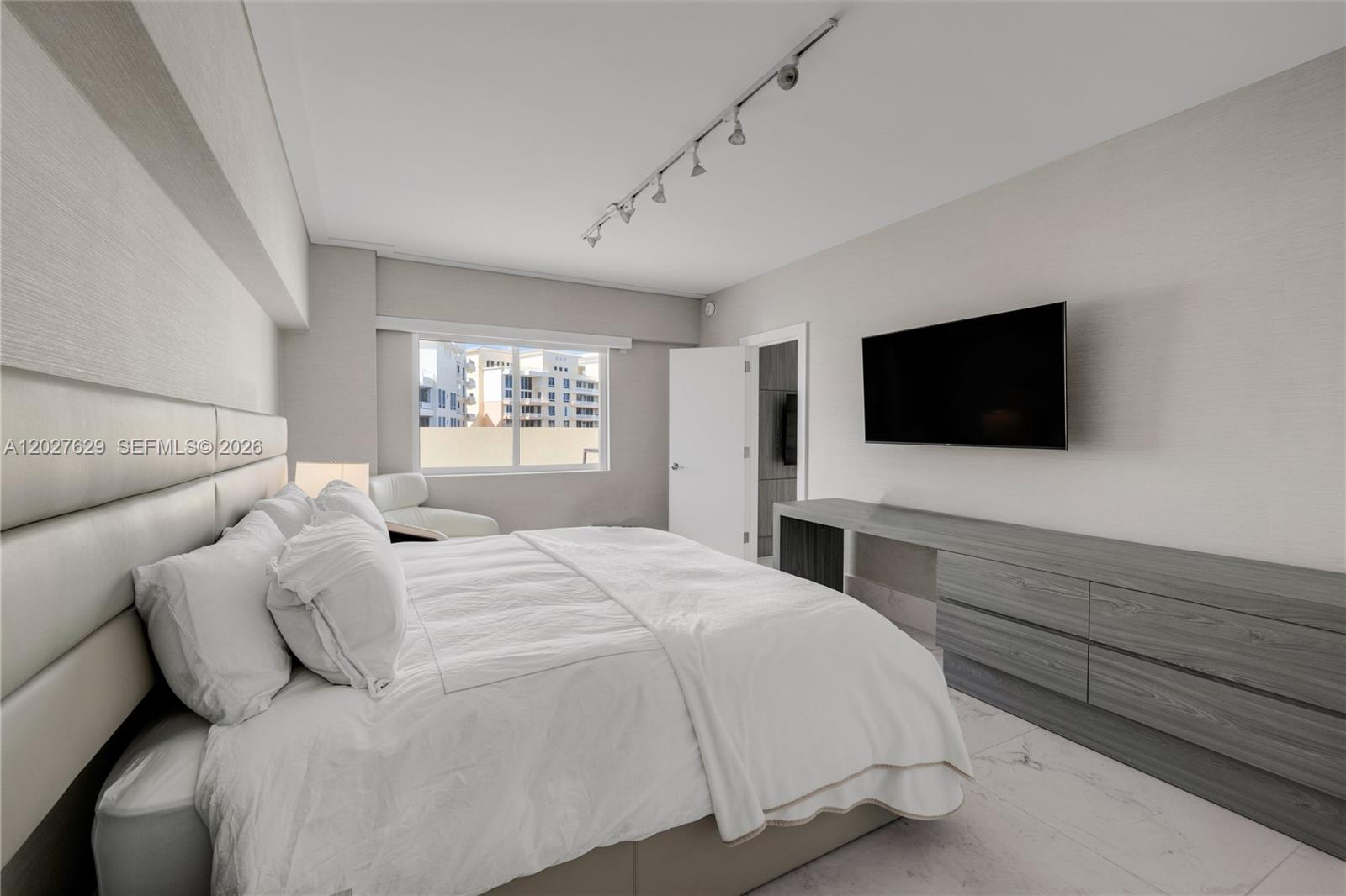 799 Crandon Boulevard, Unit PH8 Key Biscayne, FL 33149 - Photo 24 of 47 a bedroom with a bed and a flat screen tv