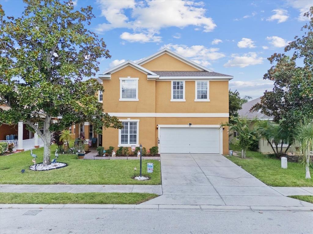 a front view of a house with a yard and garage