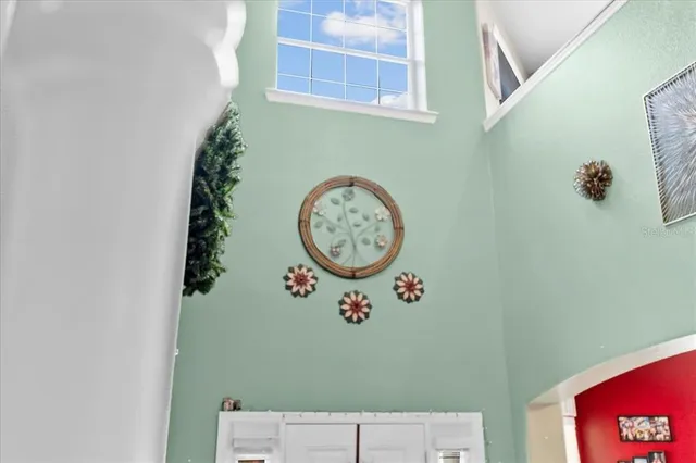 a kitchen with a sink a counter top space and living room area
